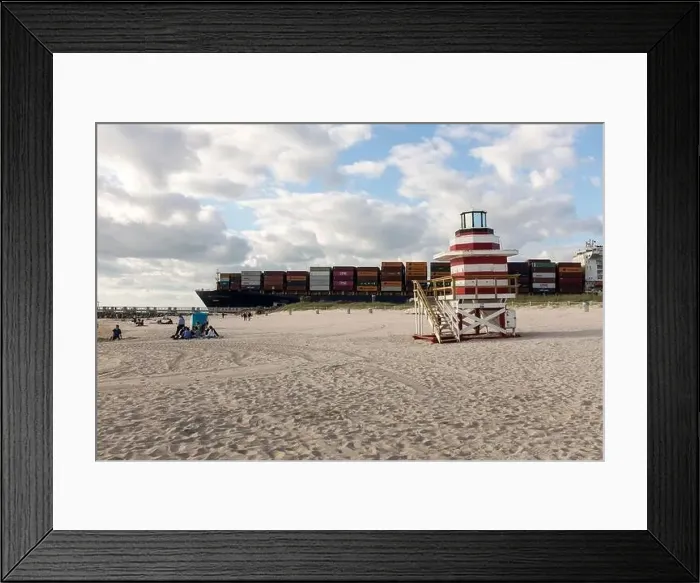 Framed Print : A fully loaded container ship sails by a lifeguard tower off South Beach, Miami Beach, Florida Framed Print : A fully loaded container ship sails by a lifeguard tower off South Beach, Miami Beach, Florida