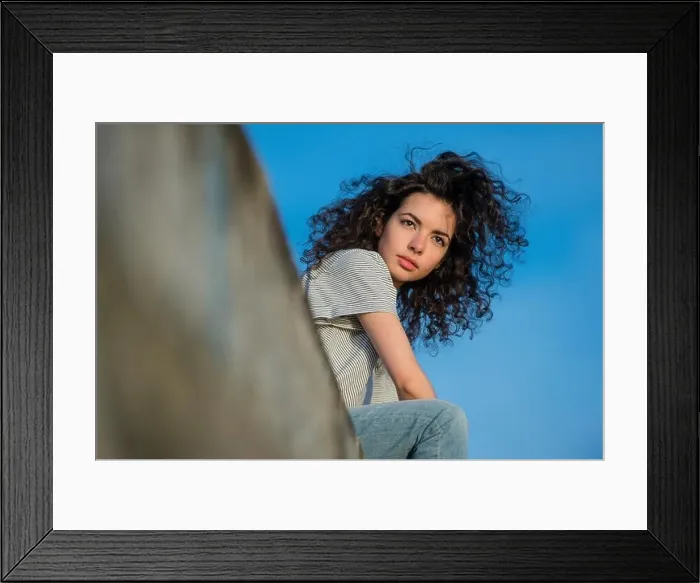 Framed Print : A young attractive slim brunette woman girl with long wild curly brown hair Framed Print : A young attractive slim brunette woman girl with long wild curly brown hair