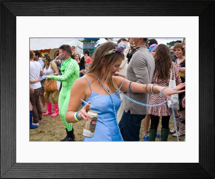 Framed Print : A woman with a can of beer and a cigarette dances in a field to a mobile sound system at the Standon Calling Festival Framed Print : A woman with a can of beer and a cigarette dances in a field to a mobile sound system at the Standon Calling Festival