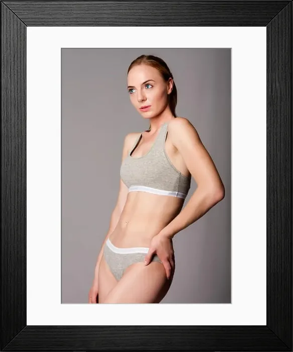 Framed Print : Beautiful attractive young woman in grey sports underwear with bra and panties showing abdomen Framed Print : Beautiful attractive young woman in grey sports underwear with bra and panties showing abdomen