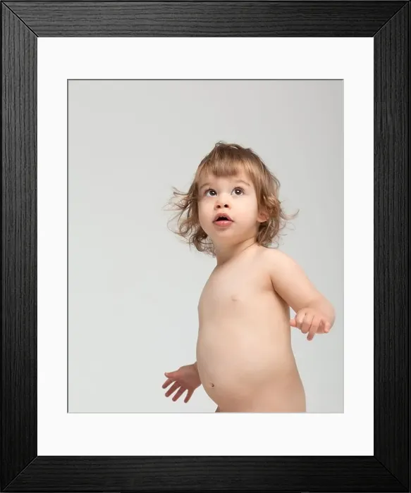 Framed Print : little preescolar looking up surprised blank space Framed Print : little preescolar looking up surprised blank space