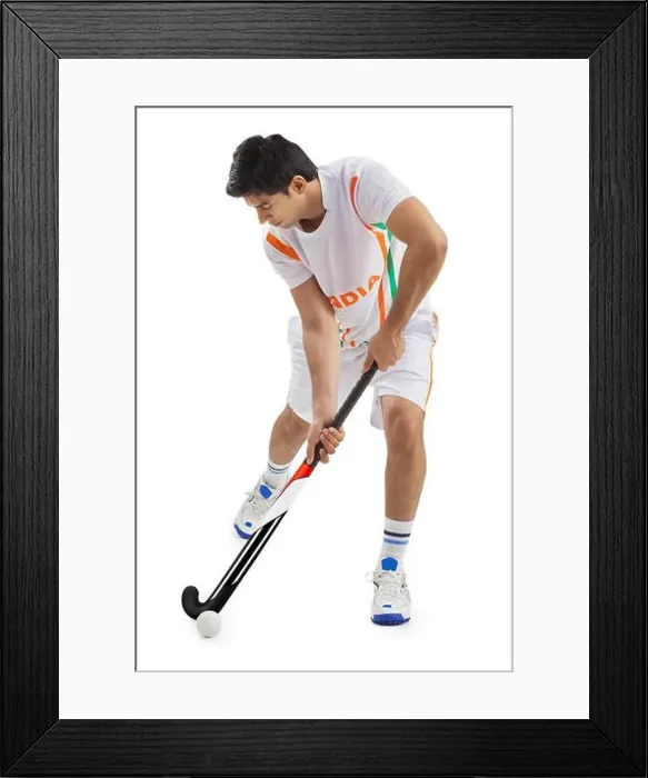 Framed Print : Man playing field hockey isolated over white background Framed Print : Man playing field hockey isolated over white background