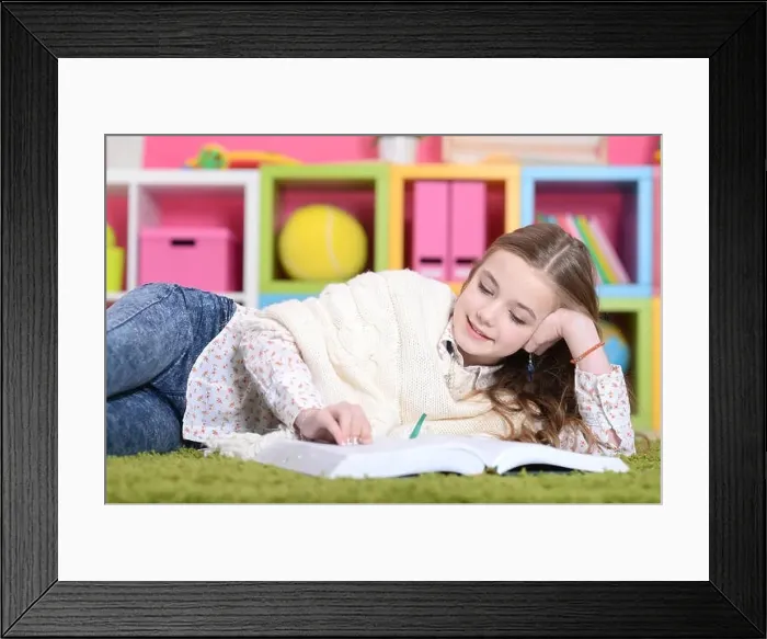 Framed Print : Portrait of cute happy girl studying at home Framed Print : Portrait of cute happy girl studying at home