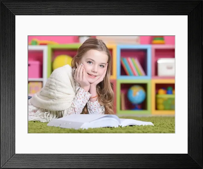 Framed Print : Portrait of cute happy girl studying at home