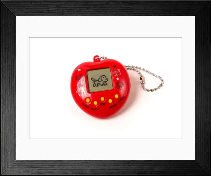 Framed Print : Retro virtual pet care game tamagotchi from 90's isolated on the white background Framed Print : Retro virtual pet care game tamagotchi from 90's isolated on the white background