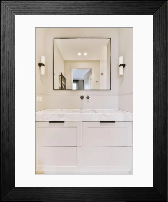 Framed Print : a bathroom with white cabinets and marble counter tops on the vanity top, along with a large mirror above it Framed Print : a bathroom with white cabinets and marble counter tops on the vanity top, along with a large mirror above it