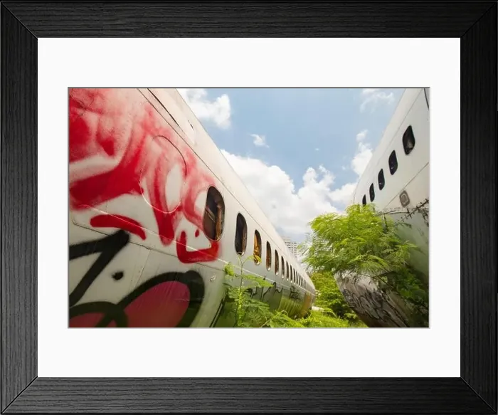 Framed Print : Remains of a wrecked and graffitied Boeing 747 and two McDonnell Douglas MD-80s in a field in Bangkok Framed Print : Remains of a wrecked and graffitied Boeing 747 and two McDonnell Douglas MD-80s in a field in Bangkok