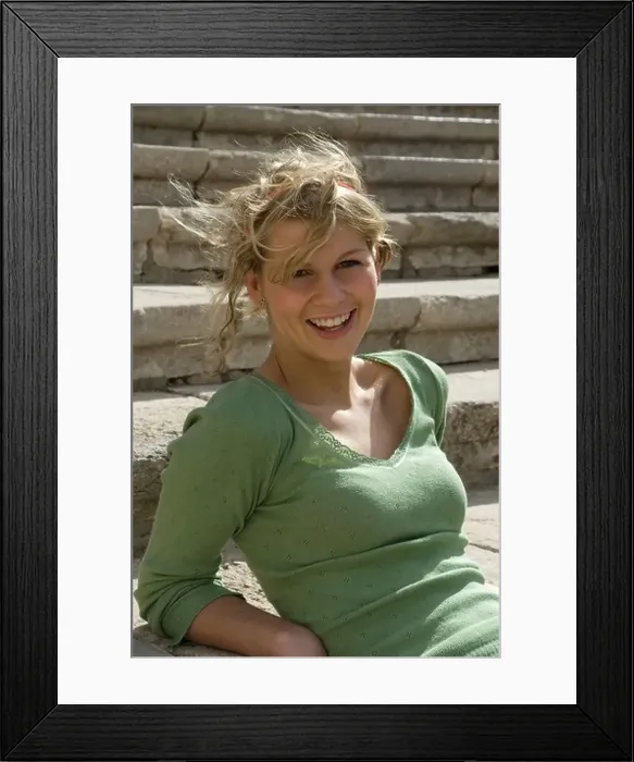Framed Print : Portrait of a teenage girl sitting on steps laughing Framed Print : Portrait of a teenage girl sitting on steps laughing