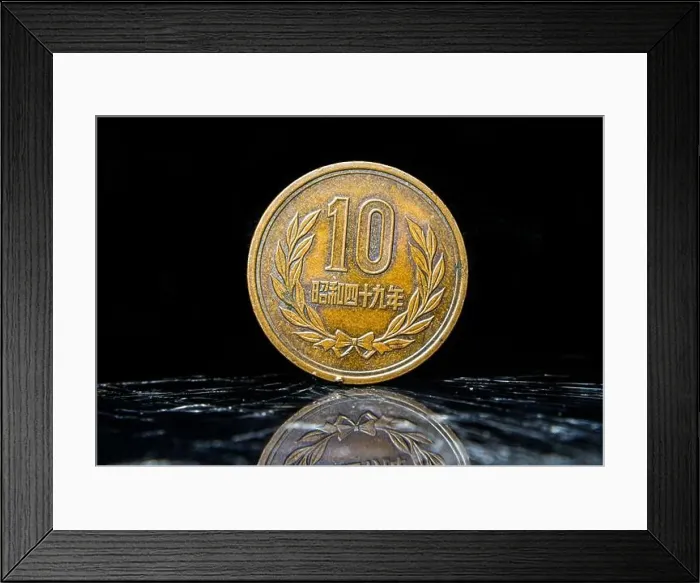 Framed Print : An aged penny sitting atop a table, displaying 10 Yen - Heisei, Japanese coin