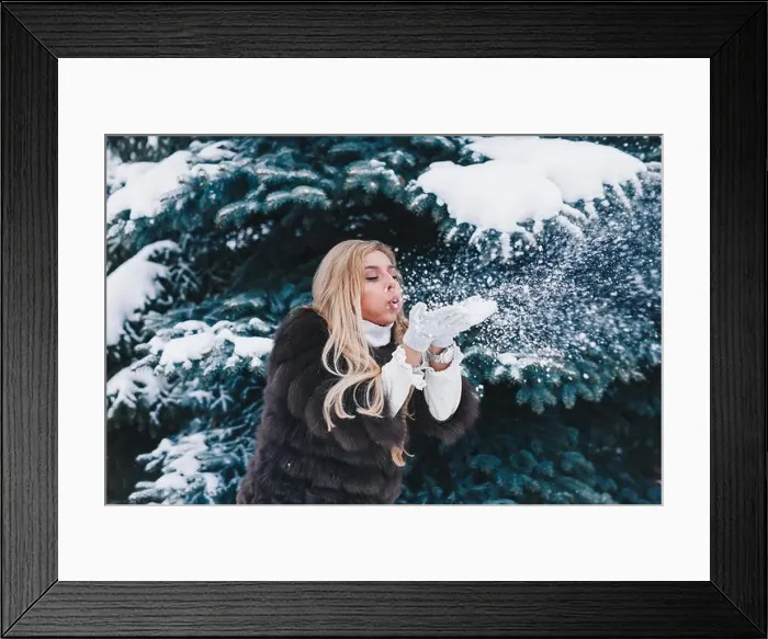 Framed Print : Christmas girl outdoor portrait. Winter woman blowing snow in a park Framed Print : Christmas girl outdoor portrait. Winter woman blowing snow in a park