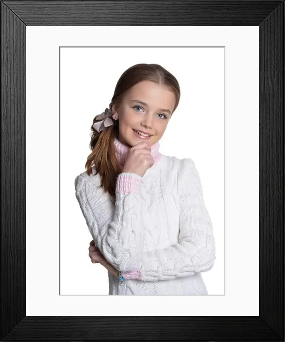 Framed Print : Portrait of smiling little girl wearing warm sweater on white background Framed Print : Portrait of smiling little girl wearing warm sweater on white background