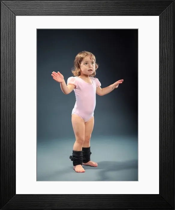 Framed Print : Studio shot of a little girl at fitness exercise Framed Print : Studio shot of a little girl at fitness exercise