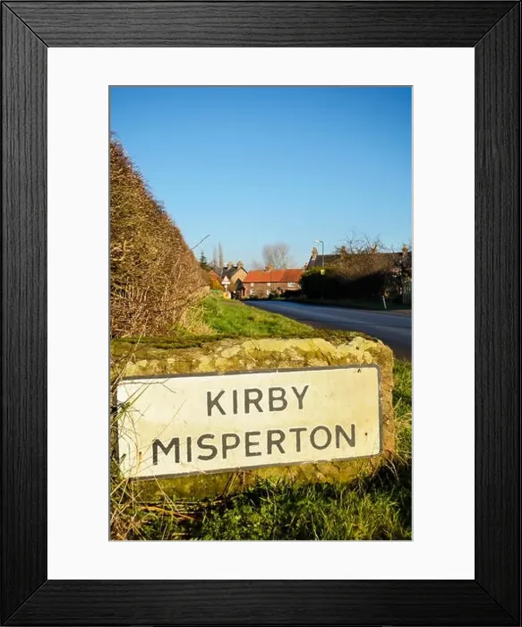 Framed Print : Name sign for the picturesque North Yorkshire village of Kirby Misperton, home of the amusement park Flamingo Land Framed Print : Name sign for the picturesque North Yorkshire village of Kirby Misperton, home of the amusement park Flamingo Land