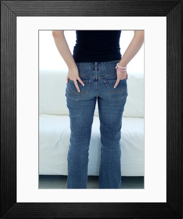 Framed Print : Young woman with her hands in her back pockets Framed Print : Young woman with her hands in her back pockets