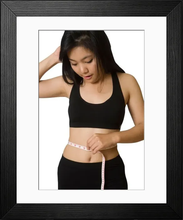 Framed Print : Attractive young Asian girl with measuring tape around her waist Framed Print : Attractive young Asian girl with measuring tape around her waist