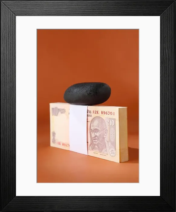 Framed Print : Pebble on bundle of ten rupee notes Framed Print : Pebble on bundle of ten rupee notes