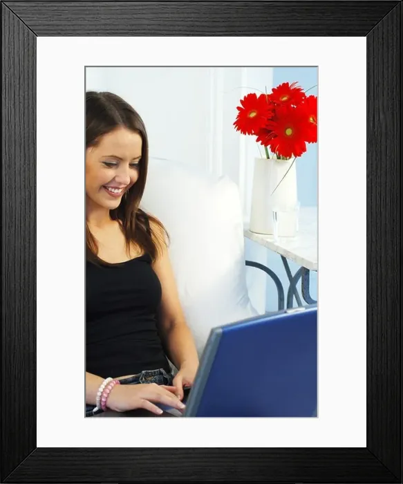Framed Print : Young woman on a laptop
