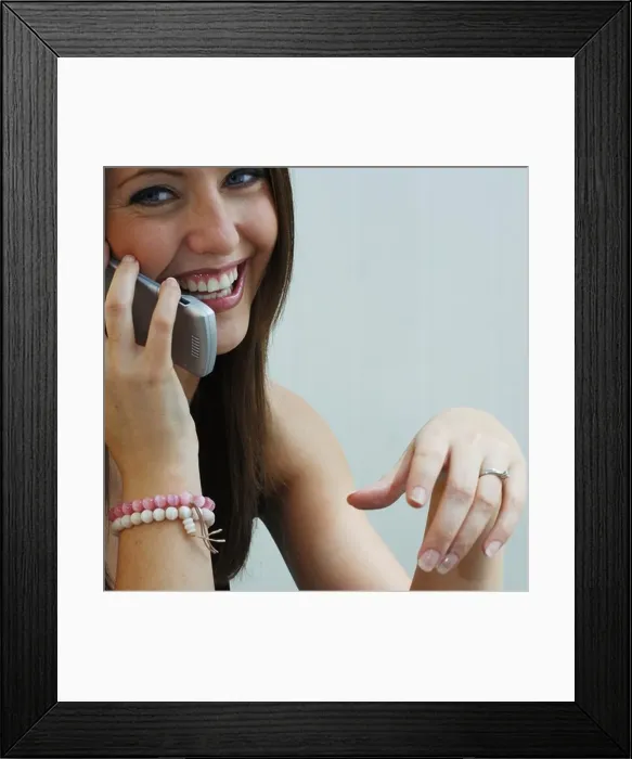 Framed Print : Young woman on mobile telephone smiling Framed Print : Young woman on mobile telephone smiling