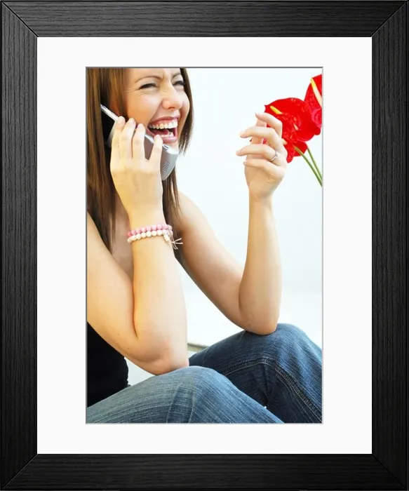 Framed Print : Young woman on mobile telephone smiling Framed Print : Young woman on mobile telephone smiling