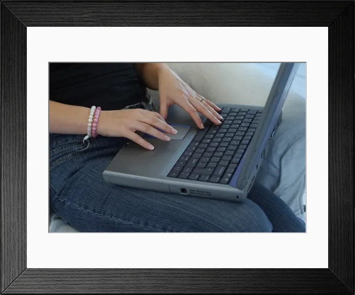 Framed Print : Womans hands typing on a laptop keyboard