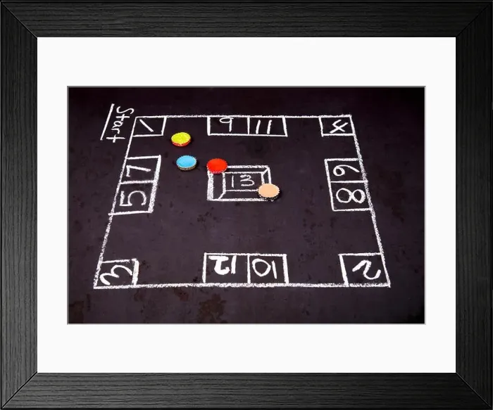 Framed Print : Skully bottle caps filled with melted crayons and setup for the game of Skully Framed Print : Skully bottle caps filled with melted crayons and setup for the game of Skully