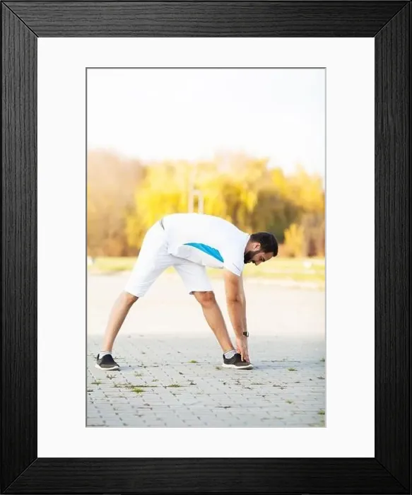 Framed Print : Fitness. Stretch man doing stretching exercise. Standing forward bend stretches of legs