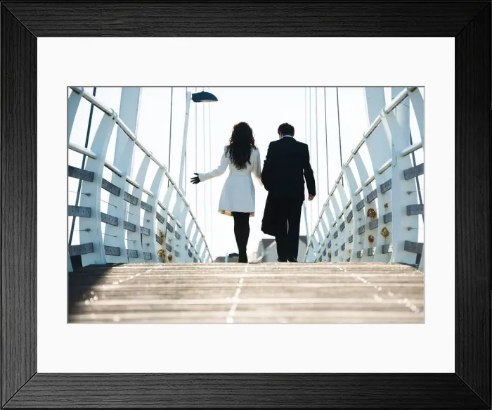 Framed Print : Rear view of two business people, man and woman, walking away over a bridge, UK Framed Print : Rear view of two business people, man and woman, walking away over a bridge, UK