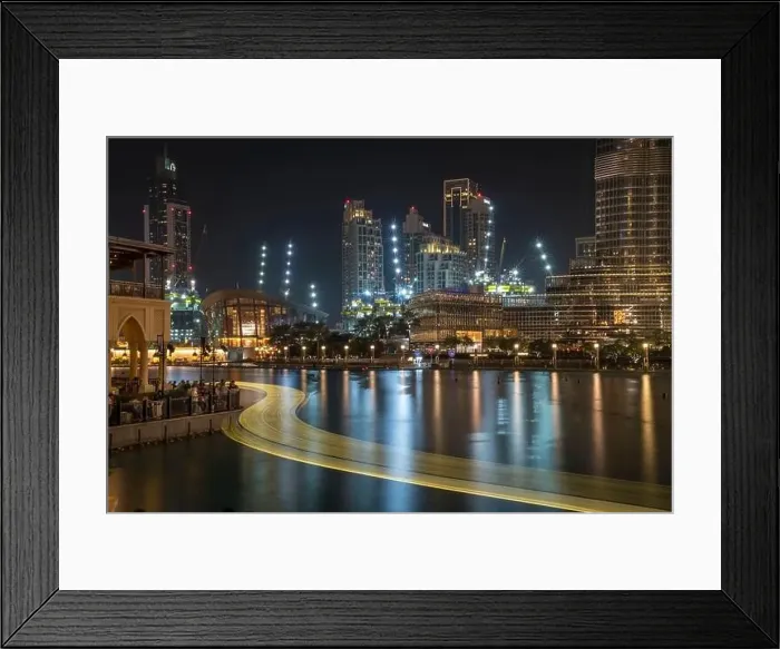 Framed Print : The lights of an abra boat wind past the Opera House and directly beneath the world's tallest building in Dubai Framed Print : The lights of an abra boat wind past the Opera House and directly beneath the world's tallest building in Dubai