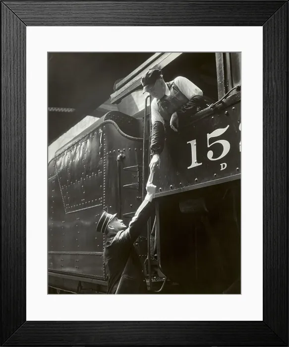 Framed Print : Train conductor giving paper to train engineer