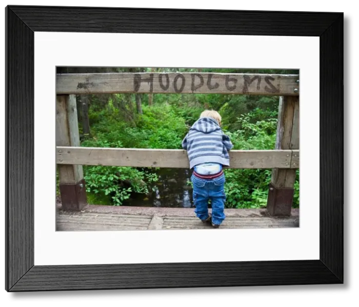 Framed Print : Young Boy Looking Over A Bridge With His Pants Falling Down And The Sign Hoodlums Over His Head Framed Print : Young Boy Looking Over A Bridge With His Pants Falling Down And The Sign Hoodlums Over His Head