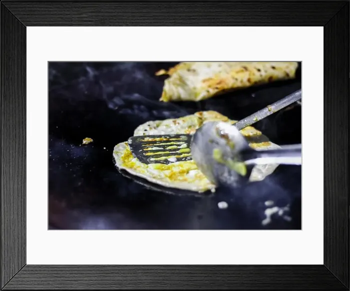 Framed Print : making of egg roll on a hot frying pan with oil and paratha and salad Framed Print : making of egg roll on a hot frying pan with oil and paratha and salad