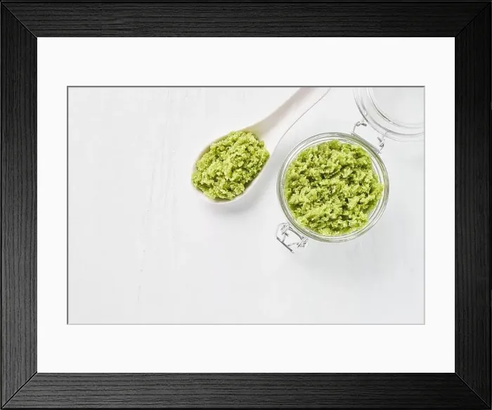 Framed Print : Homemade green body scrub in a glass jar on a white background