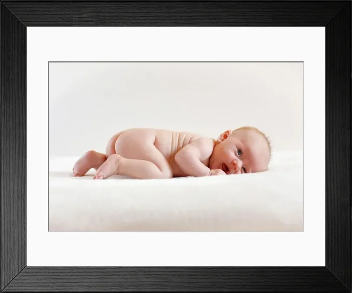 Framed Print : Baby girl, 3 months old, lying on a sheepskin Framed Print : Baby girl, 3 months old, lying on a sheepskin