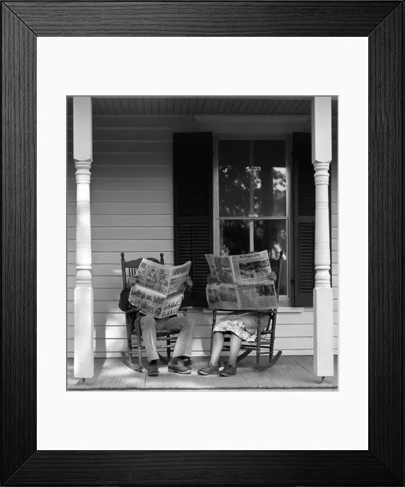 Framed Print : 1950s 1960s COUPLE MAN WOMAN SITTING ON PORCH IN ROCKING CHAIRS HOLDING NEWSPAPERS UP HIDING THEIR FACES Framed Print : 1950s 1960s COUPLE MAN WOMAN SITTING ON PORCH IN ROCKING CHAIRS HOLDING NEWSPAPERS UP HIDING THEIR FACES