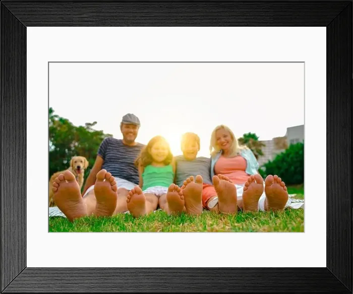 Framed Print : Happy family lying outdoors in the park. Family relaxing on the grass. Close up of feet - Image Framed Print : Happy family lying outdoors in the park. Family relaxing on the grass. Close up of feet - Image