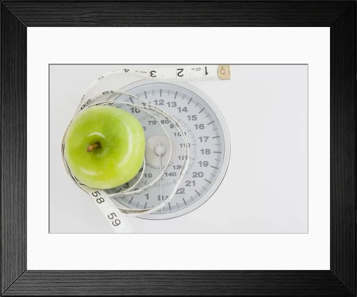 Framed Print : Green apple circled with a tape measure and weigh-scale Framed Print : Green apple circled with a tape measure and weigh-scale