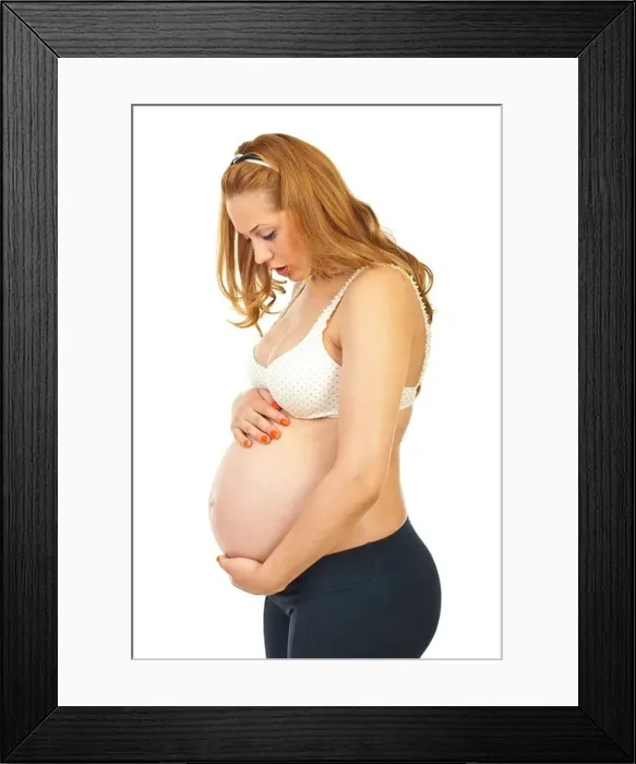 Framed Print : Profile of surprised pregnant woman of her baby movements isolated on white background Framed Print : Profile of surprised pregnant woman of her baby movements isolated on white background