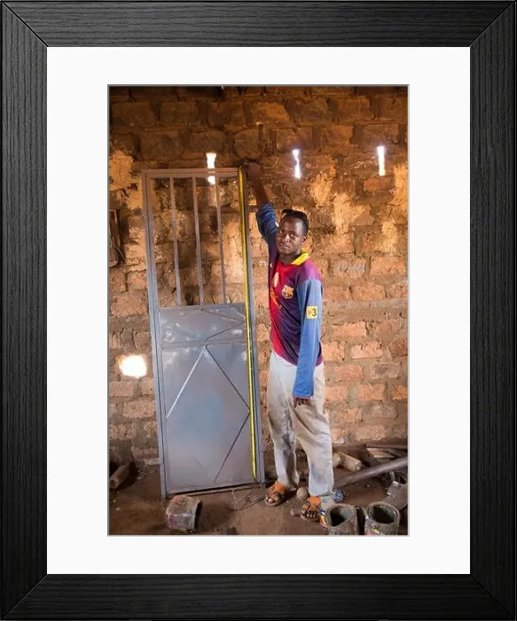 Framed Print : Kiniero, Guinea, 30th April 2015: Metal and welding workshop making doors and doing repairs Framed Print : Kiniero, Guinea, 30th April 2015: Metal and welding workshop making doors and doing repairs