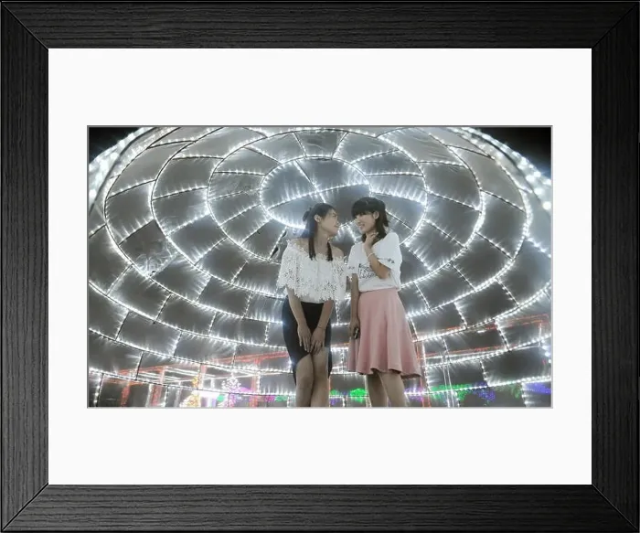 Framed Print : Visitors talk under an installation of LED lights during a light art festival at Huahai Park in Taiyuan city