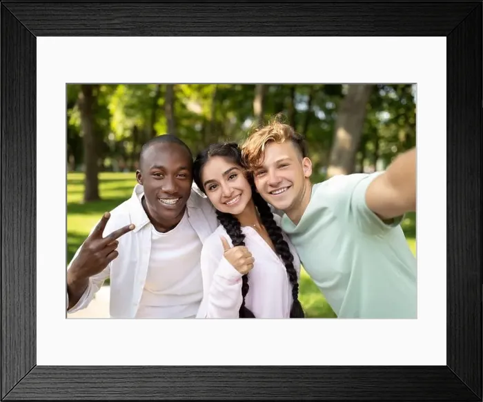 Framed Print : Multiracial students friends making selfie, gesturing v-sign and showing thumb up, posing outdoors in campus