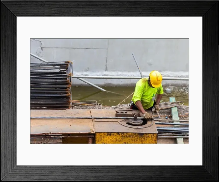 Framed Print : asian construction worker is using steel bending machine bender rebar for casting foundation concrete pillars