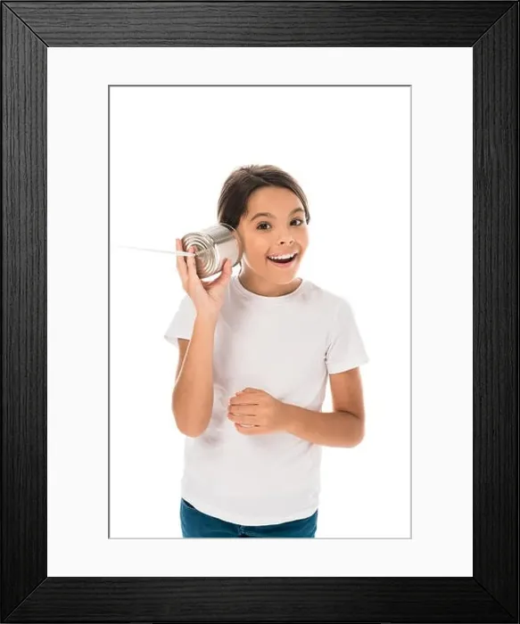 Framed Print : cheerful kid holding tin can near ear isolated on white