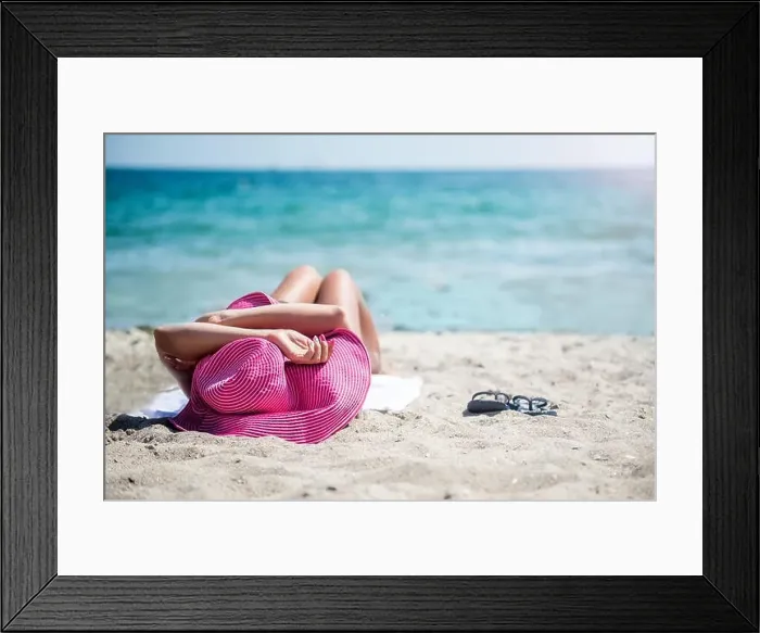 Framed Print : Woman in hat relaxing on beach Framed Print : Woman in hat relaxing on beach