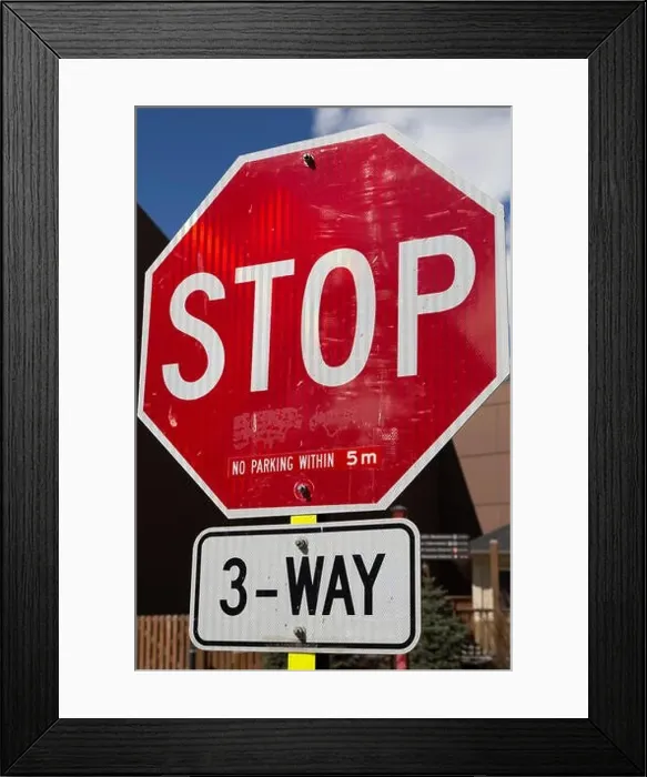 Framed Print : A stop sign on a street in Banff, Alberta, Canada. Parking is restricted around the three way junction Framed Print : A stop sign on a street in Banff, Alberta, Canada. Parking is restricted around the three way junction