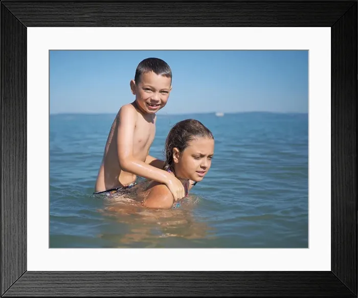 Framed Print : Little girl and littel boy playing in water Framed Print : Little girl and littel boy playing in water