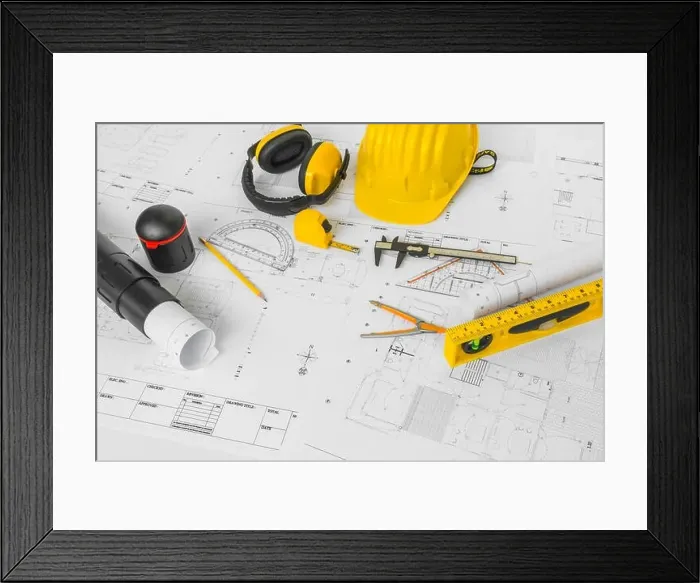 Framed Print : Construction plans with yellow helmet and drawing tools on blueprints Framed Print : Construction plans with yellow helmet and drawing tools on blueprints
