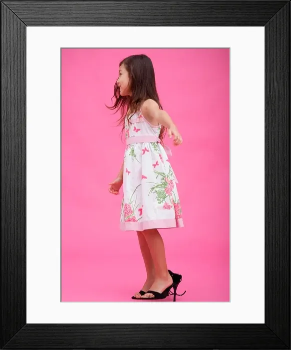 Framed Print : Young girl wearing high heel shoes, side view Framed Print : Young girl wearing high heel shoes, side view