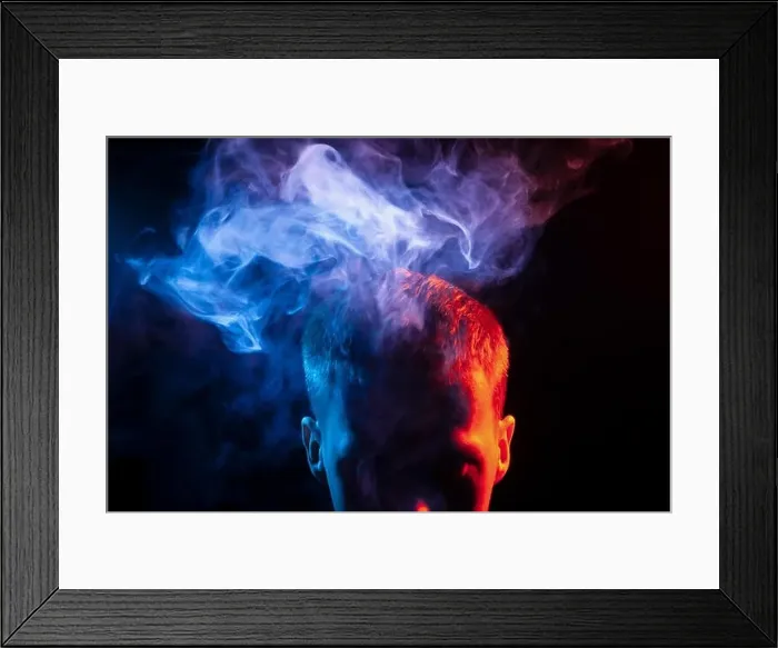 Framed Print : The face of a man in shadow and head is highlighted in red Framed Print : The face of a man in shadow and head is highlighted in red