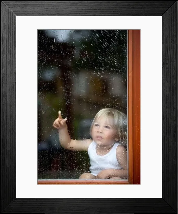 Framed Print : Sad child behind the window on a rainy day Framed Print : Sad child behind the window on a rainy day