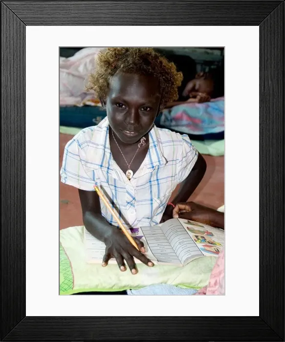 Framed Print : Schoolgirl passenger studying aboard an inter-island steamer whilst another child sleeps, Solomon Islands Framed Print : Schoolgirl passenger studying aboard an inter-island steamer whilst another child sleeps, Solomon Islands